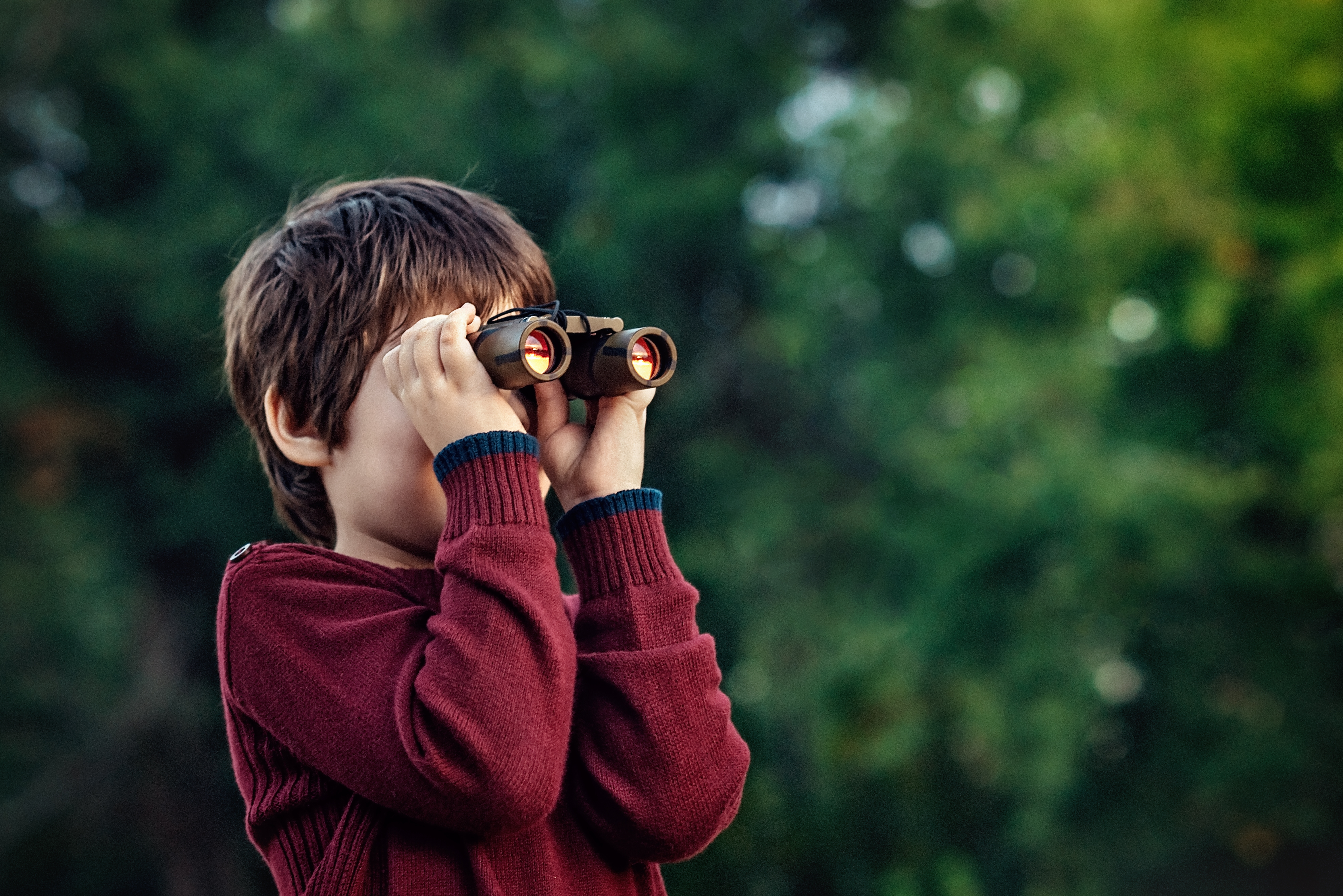 Child exploring with binoculars
